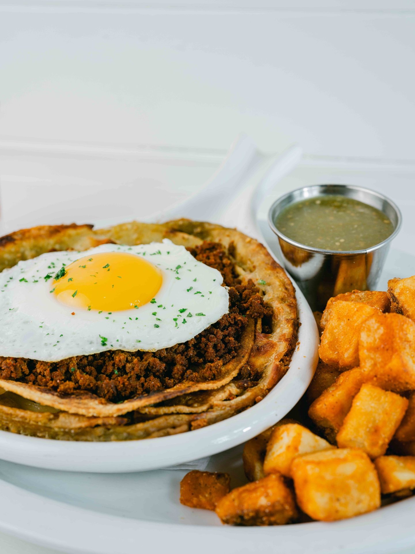Chorizo chilaquiles with a sunny egg and salsa verde