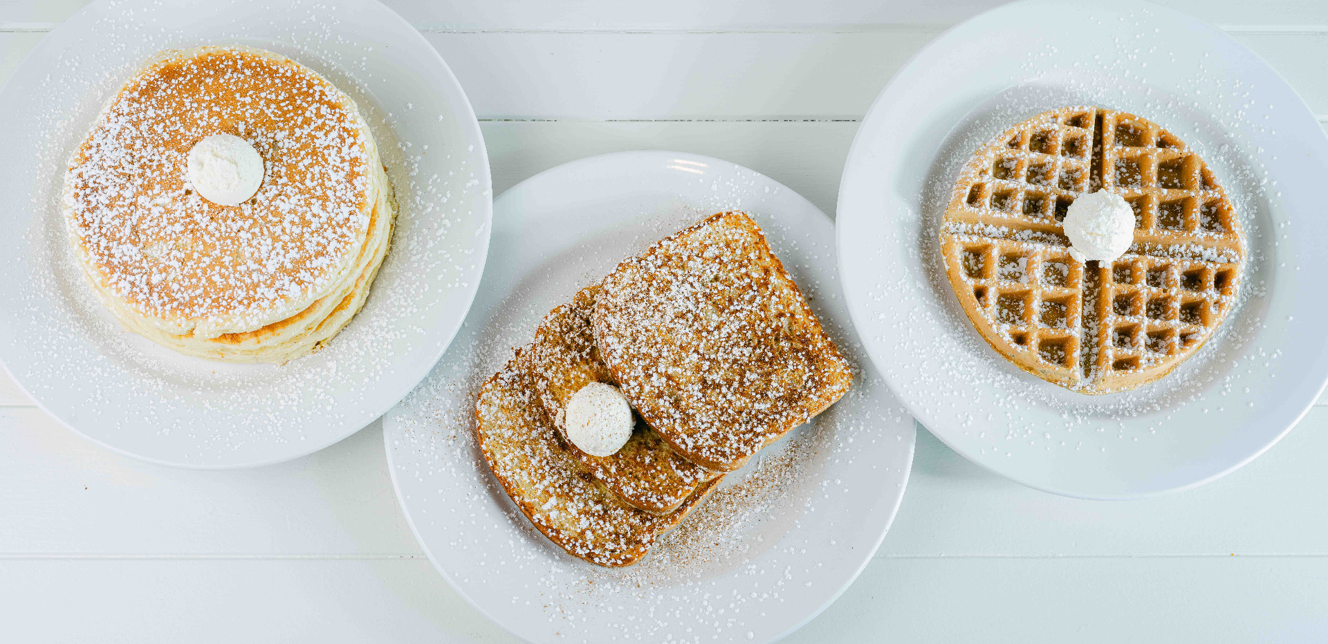 The signature trio — fluffy pancakes, cinnamon French toast and a Belgian waffle